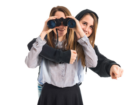 Twin sisters with binocularsの写真素材