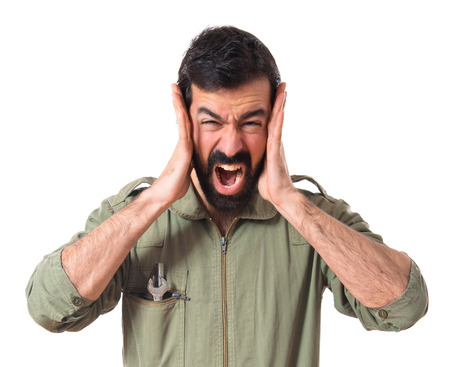 frustrated mechanic over white backgroundの写真素材