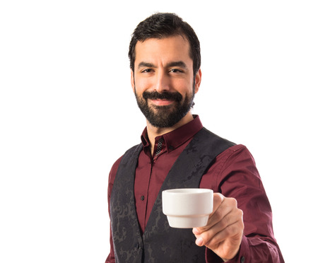 Man wearing waistcoat holding a cup of coffeeの写真素材