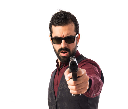 Man wearing waistcoat shooting with a pistolの写真素材