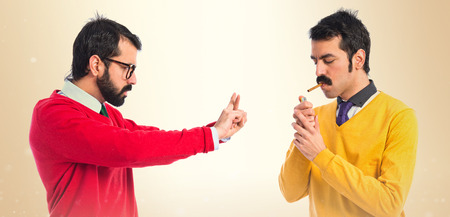 angry man because his brother smokesの写真素材