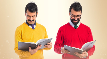 Twin brothers reading book