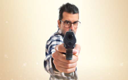 Posh boy shooting with a pistolの写真素材