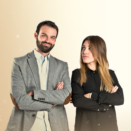 Couple with their arms crossed over isolated backgroundの写真素材