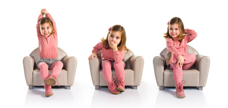 Surprised girl sitting on armchairの写真素材