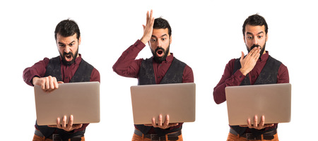 Man wearing waistcoat with laptopの写真素材