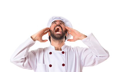 frustrated chef over white backgroundの写真素材