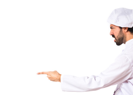 Chef shouting and pointing over white の写真素材