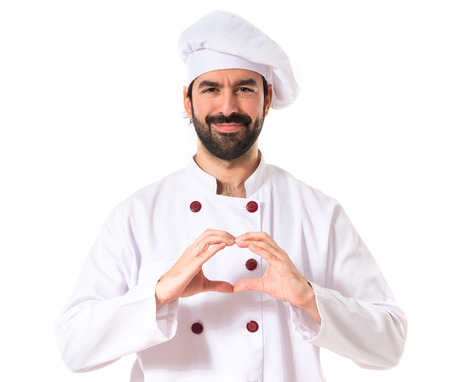 Chef making a heart with her handsの写真素材