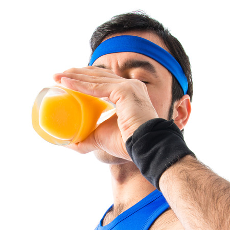 Sportman drinking orange juiceの写真素材