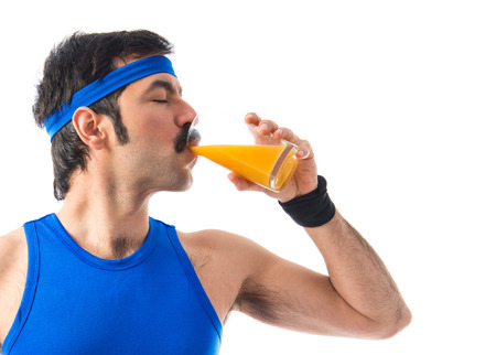 Vintage sportman drinking orange juiceの写真素材