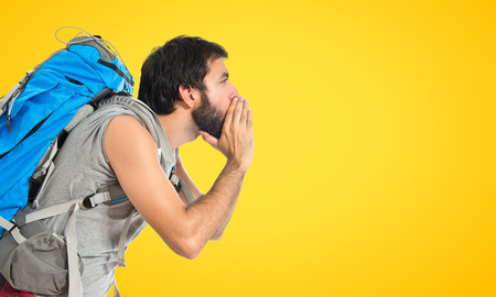 Backpacker shouting over isolated white backgroundの写真素材