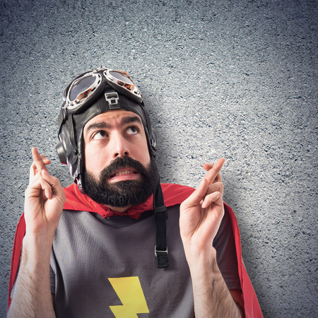 Superhero with his fingers crossingの写真素材