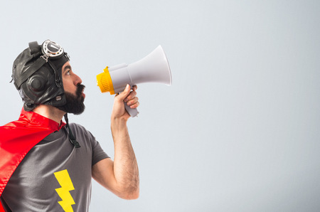 Superhero shouting by megaphoneの写真素材