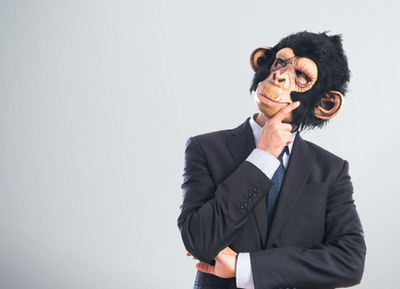 Monkey man thinking over white backgroundの写真素材