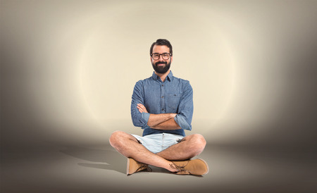 Young hipster man with his arms crossedの写真素材