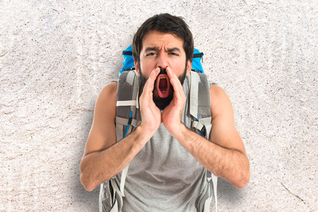 Backpacker shouting over isolated white backgroundの写真素材