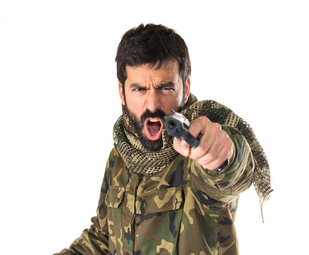 Soldier shooting a gunの写真素材