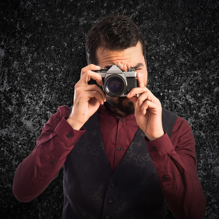 Man wearing waistcoat photographingの写真素材