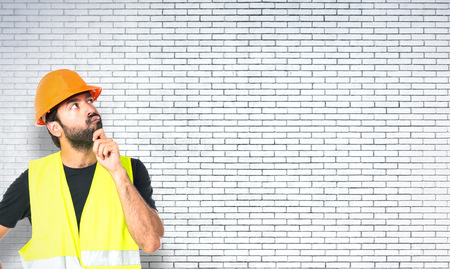 Workman thinking over isolated white background