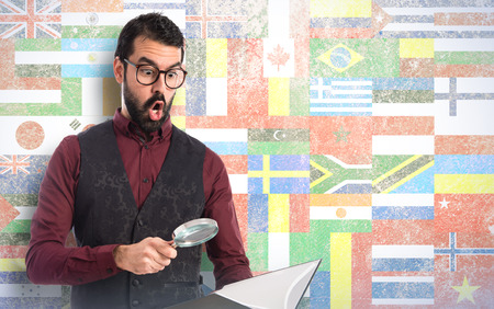 Man wearing waistcoat with magnifying glassの写真素材