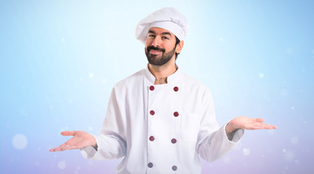 Chef having doubts over white backgroundの写真素材