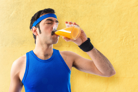 Sportman drinking orange juiceの写真素材