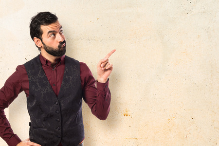 Man wearing waistcoat thinkingの写真素材