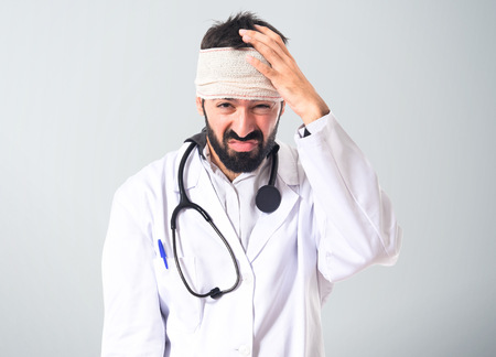 Doctor with headache over white backgroundの写真素材