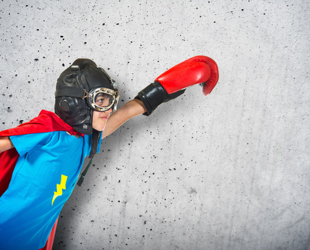 Child dressed like superhero with boxing glovesの写真素材