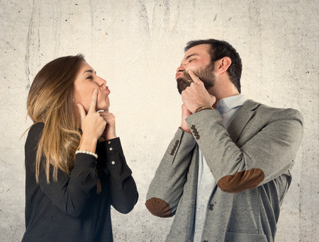 Cute couple over isolated white backgroundの写真素材