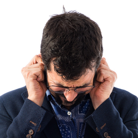 Vintage young man covering his ears