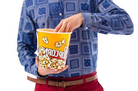 Vintage young man eating popcornの写真素材