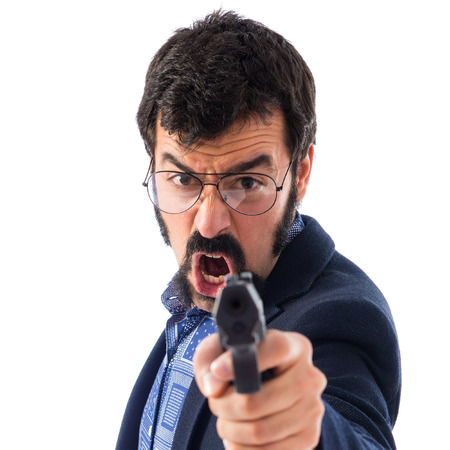 Vintage young man shooting with a pistolの写真素材