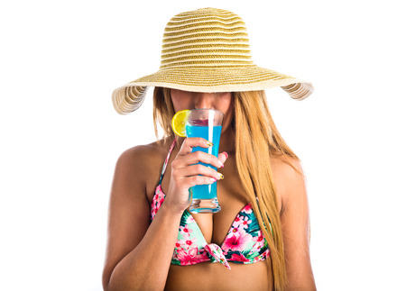 Young woman in bikini drinking a cocktailの写真素材