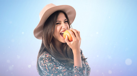 Pretty woman eating an appleの写真素材