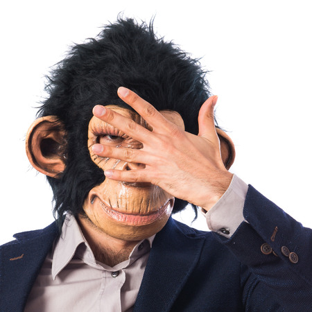 Monkey man covering his face