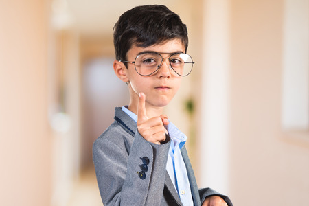 Child with vintage glasses pointing to the front