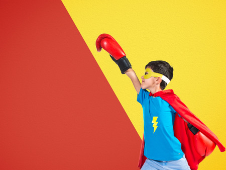 Child dressed like superhero with boxing glovesの写真素材
