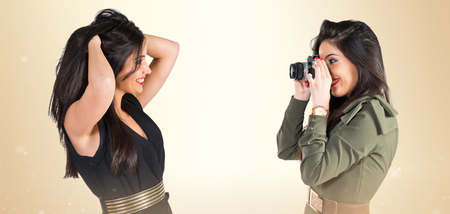 Woman photographing her friendの写真素材