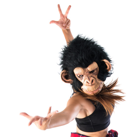 Woman with monkey mask jumping in hip hop styleの写真素材