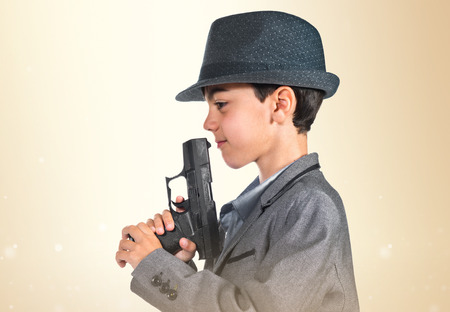 Gangster boy holding a pistolの写真素材