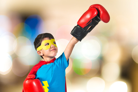 Child dressed like superhero with boxing glovesの写真素材
