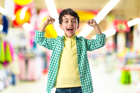Lucky brunette kid over isolated white backgroundの写真素材