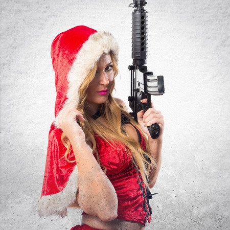 Christmas woman holding a pistolの写真素材