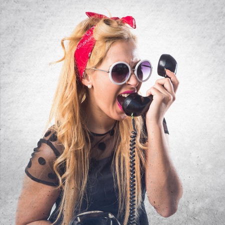 Pin-up girl talking to vintage phoneの写真素材