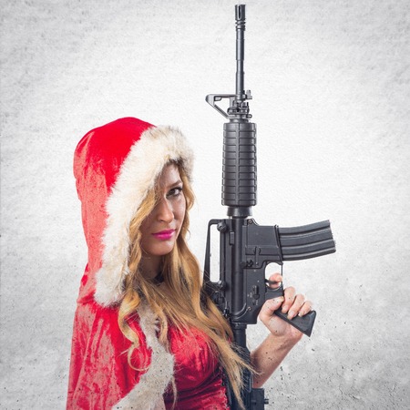 Christmas woman holding a pistolの写真素材