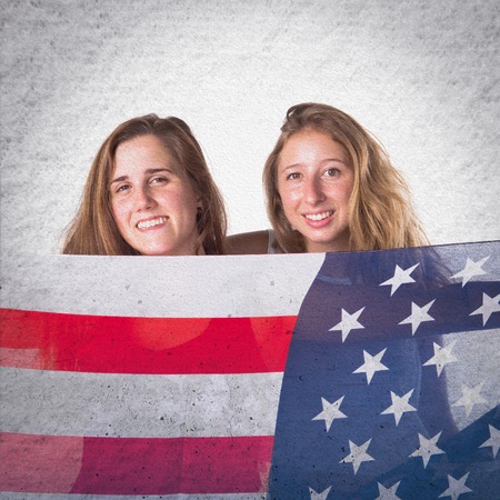 Friends holding an american flagの写真素材