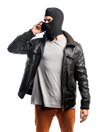 Robber talking to mobileの写真素材