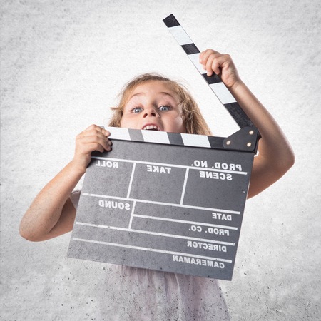 Girl holding a clapperboardの写真素材